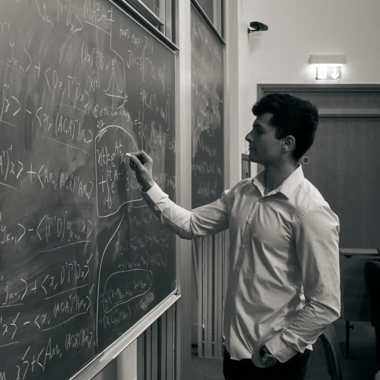 Avi writing on chalkboard